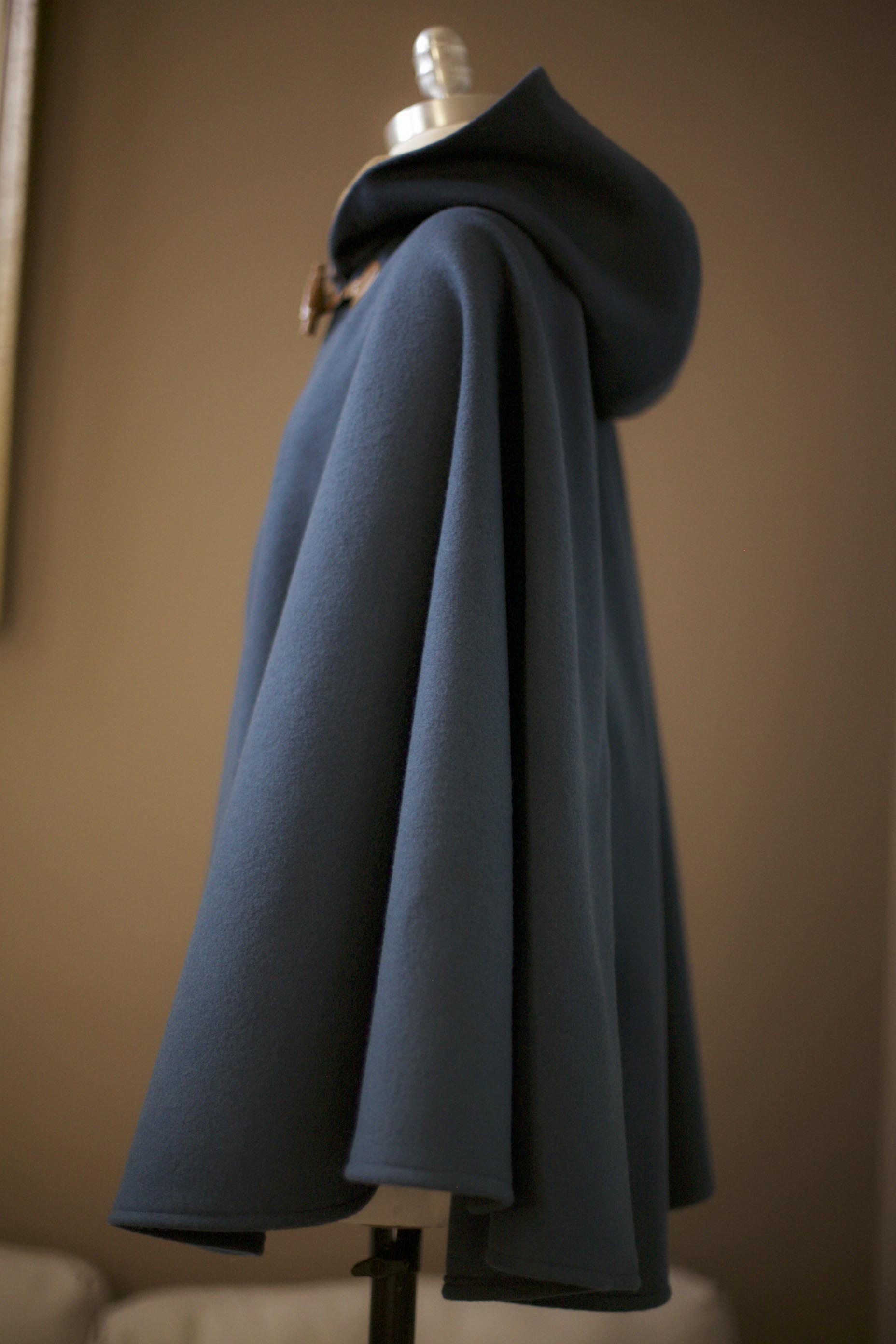 teal cape with leather toggle