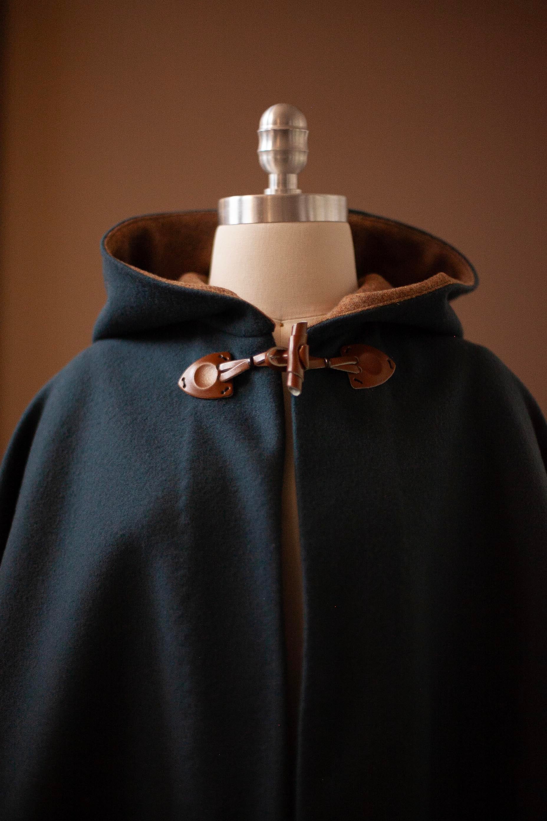 dark teal cape with leather