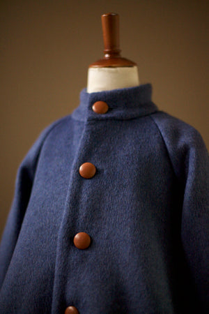 blue coat with leather buttons