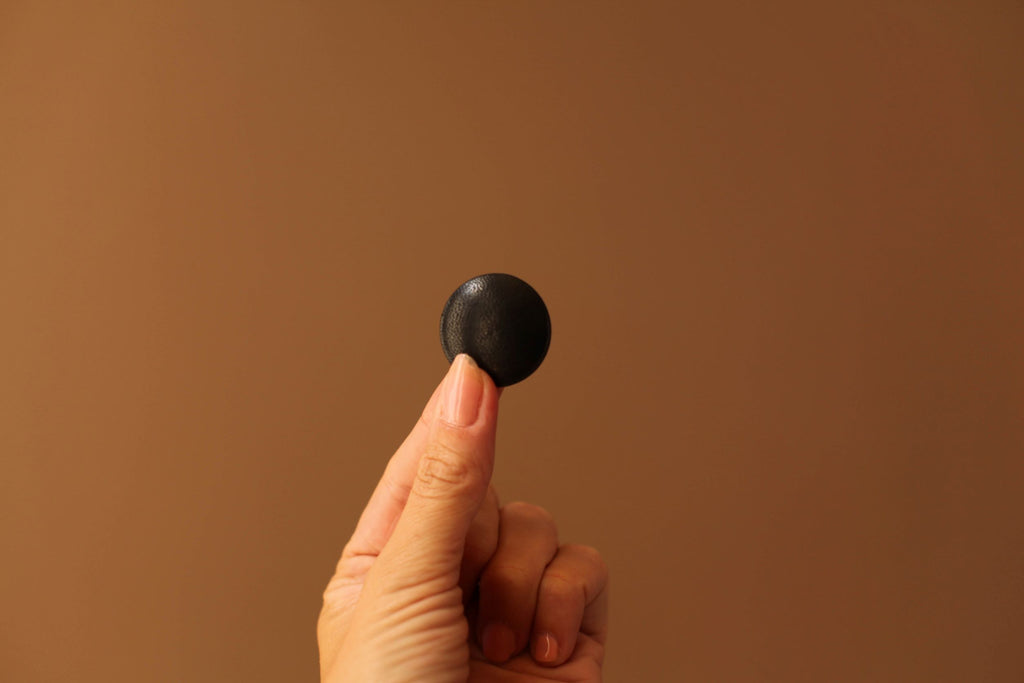 black leather button